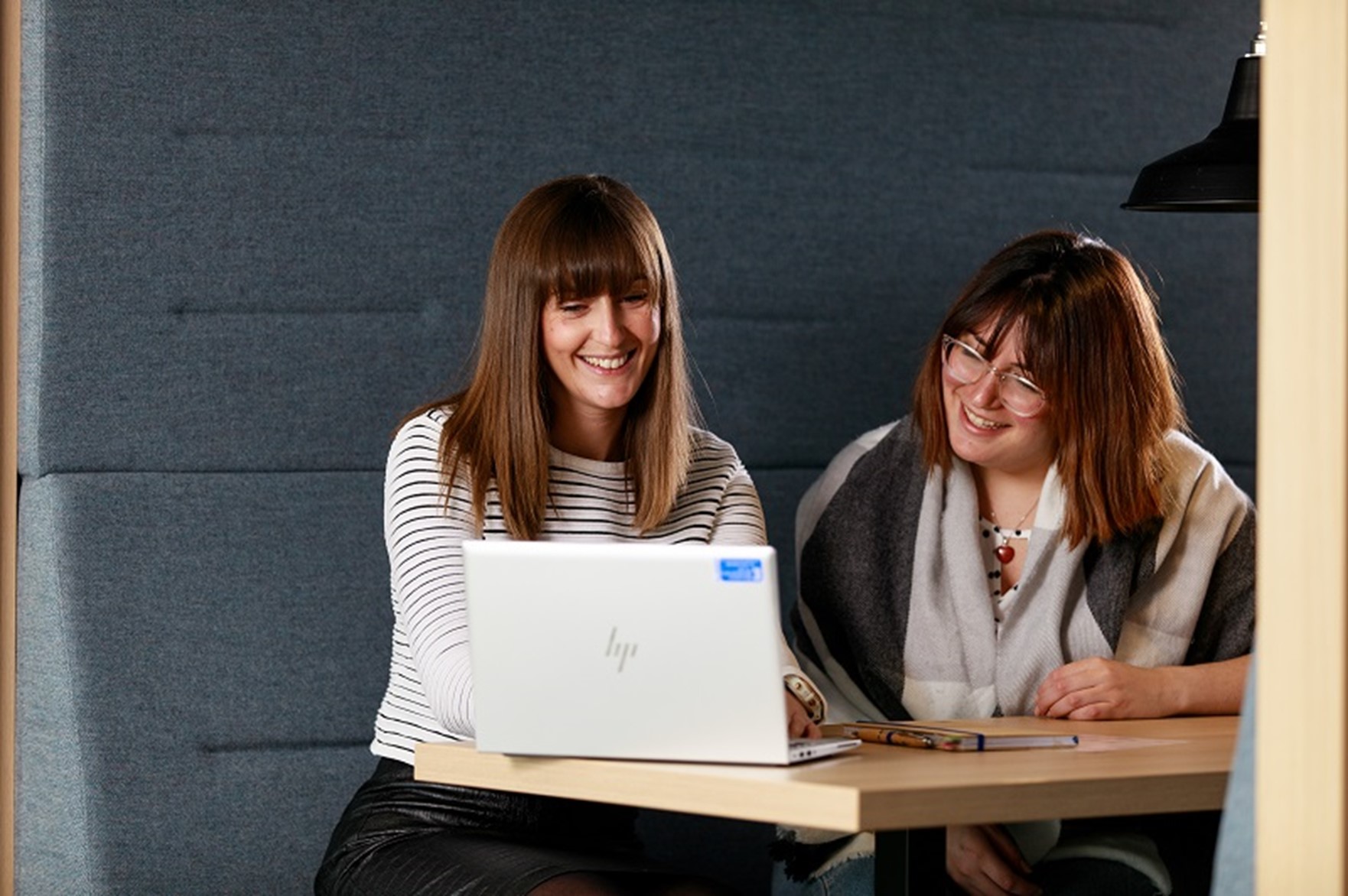 A couple of women looking at a computer