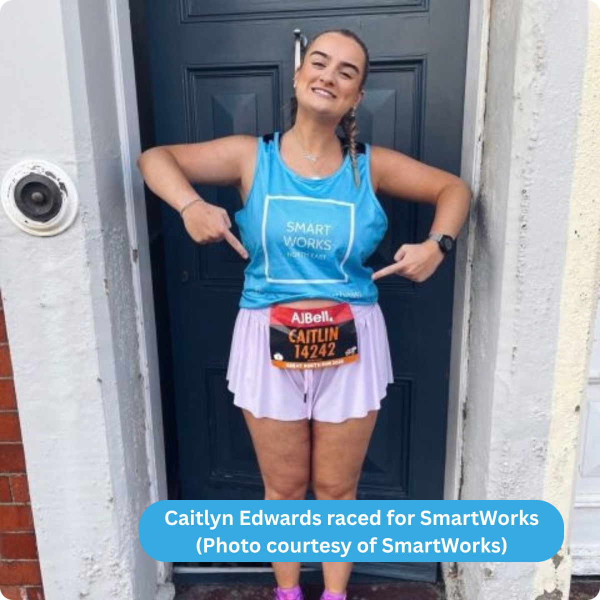 Photo of Caitlyn in front of a door pointing at her runner number
