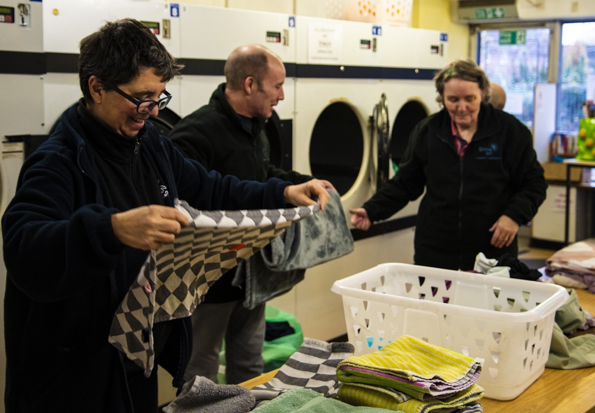 Photo of people working in a community launderette