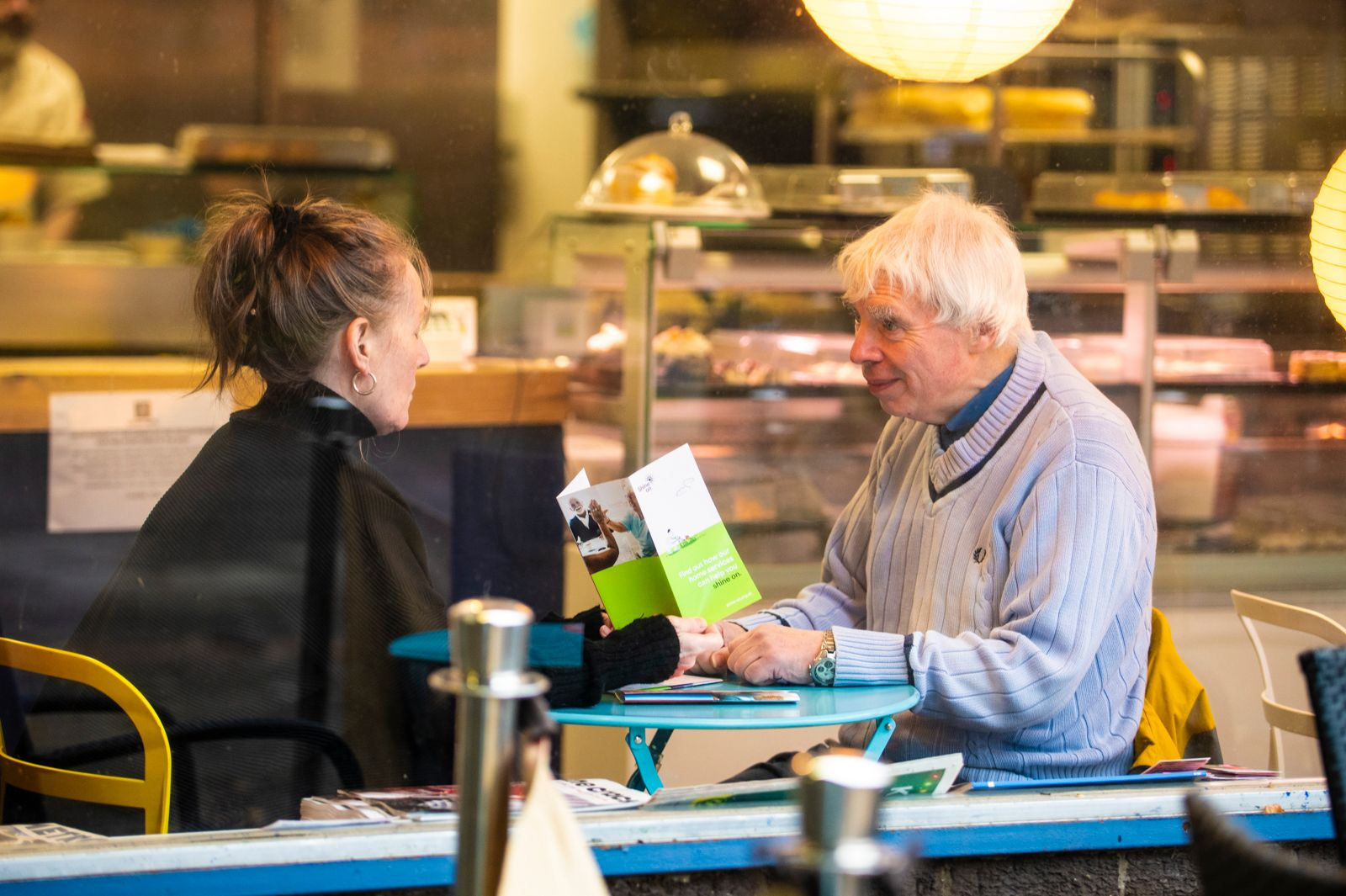 Photo of two people sitting in a coffee shop